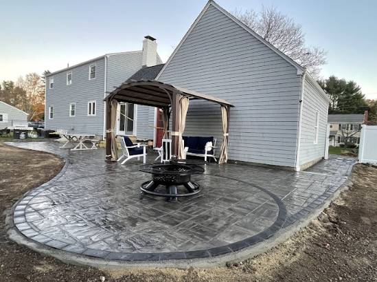 modern landscaping materials, carefully arranged, creating a contemporary garden bed, photorealistic, in a minimalistic garden with succulents and ornamental grasses, highly detailed, displaying clean lines and neat arrangement, mid-range view, neutral colors, golden hour light, shot with a prime lens