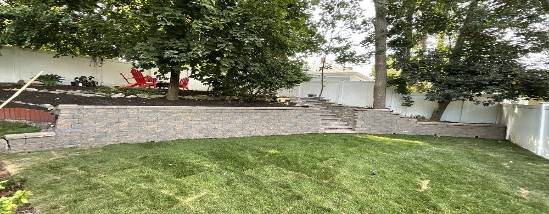advanced wall installation, workers operating, photorealistic, industrial backdrop with concrete mixers and loaders, highly detailed, building materials arranged neatly, shot with a 28mm lens, gray tones, overcast lighting