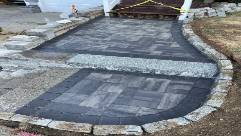 durable retaining wall, team at work, photorealistic, mountainous terrain with rocky outcrops, highly detailed, large stones and specialized machinery, shot with a 24mm lens, cool colors, bright daylight